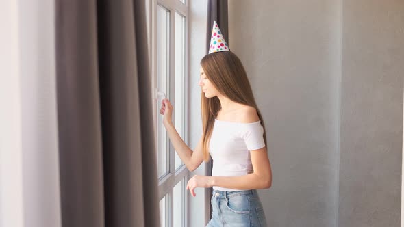 Birthday Young Woman Waiting for Guests Near Window.