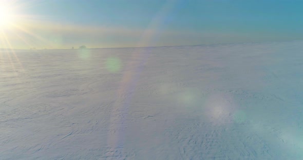 Aerial View of Cold Winter Landscape Arctic Field Trees Covered with Frost Snow Ice River and Sun