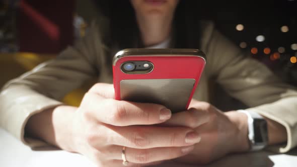 Girl in a Cafe Works on the Phone, Keep Your Smartphone in Your Hands.