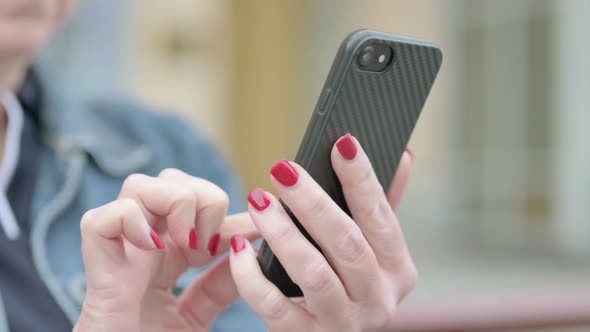 Close Up of Female Hand Using Smartphone Outdoor