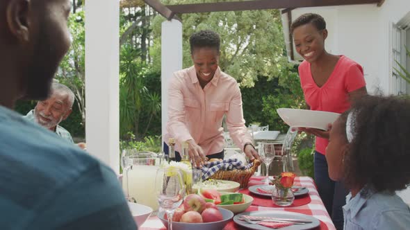 Happy family eating together at table