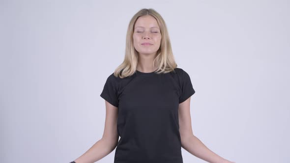 Young Happy Blonde Woman Relaxing with Eyes Closed