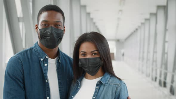 Black Tourists Couple Wearing Protective Face Masks Standing In Airport