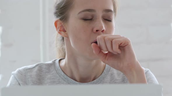 Young Woman Coughing at Work