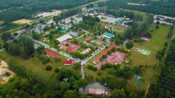 Cinematic Drone Footage of Palm Oil Mill Effluent residential consists of buildings, homes, main roa