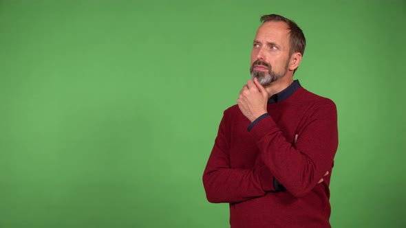 A Middleaged Handsome Caucasian Man Thinks About Something  Green Screen Background