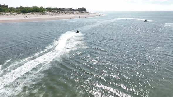 An aerial view over Gravesend Bay in Brooklyn, NY as two jet ski riders enjoys the sunny day. The dr