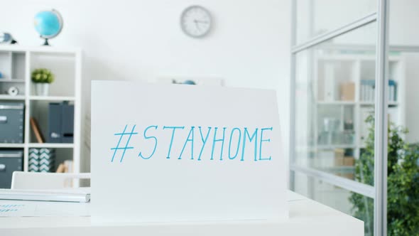 Empty Office Room with No People During Covid-19 Pandemic and Banner Stayhome Hashtag alt