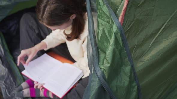 Reading a Book in a Tent