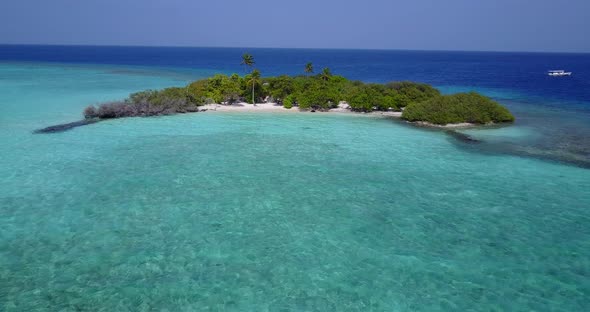 Tropical aerial tourism shot of a white sandy paradise beach and blue sea background in high resolut