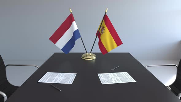 Flags of Netherlands and Spain on the Table