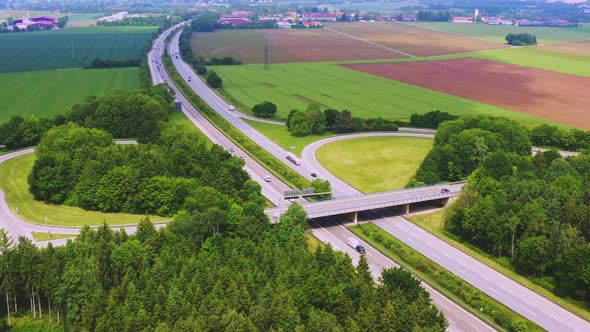Timelapse of a droneshot next to a german Autobahn with much driving cars, smootly zoomed out from t