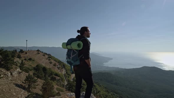 A young, male tourist climbs the mountains.