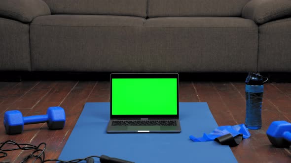 Laptop Display Green Screen Stand on Fitness or Yoga Mat on Home Sofa Background