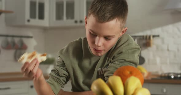 Boy Eating in Kitchen Alone