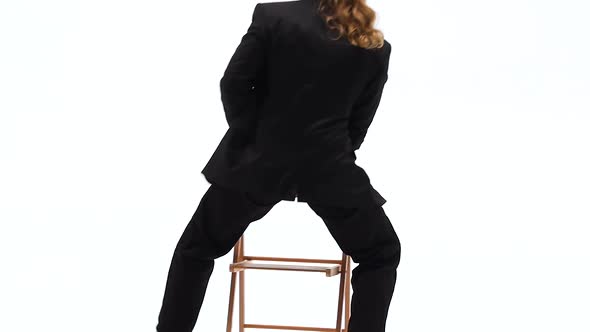 Elegant Man in a Black Hat Is Dancing an Erotic Dance. He Uses a Chair and a Cigarette. White