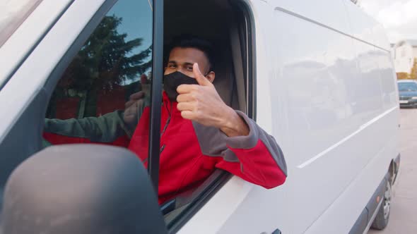 Young Indian Man with Face Mask Showing Thumb Up From the Van