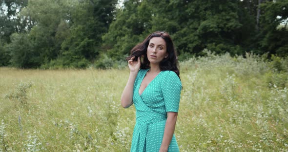 Brunette In A Turquoise Dress In Nature