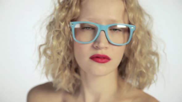 Young woman looking over glasses