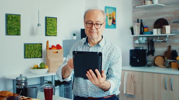 Older Man Holding Tablet Pc