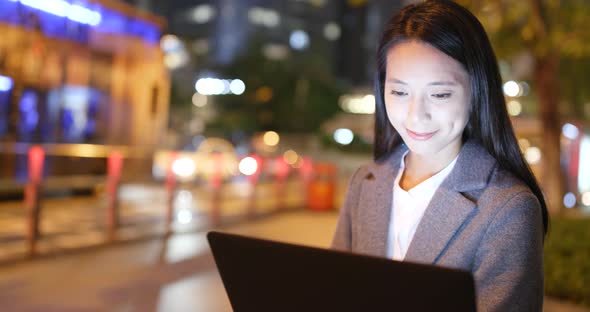 Business Woman Use of Laptop Computer at Night