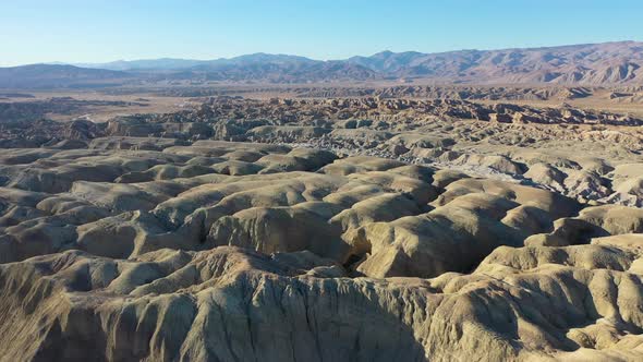 Aerial flyover Arroyo Tapiado Mud Cave Landscape during sunny day and blue sky in California