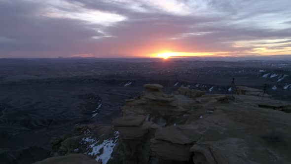 Panning view at sunrise from edge of a cliff in the Utah desert