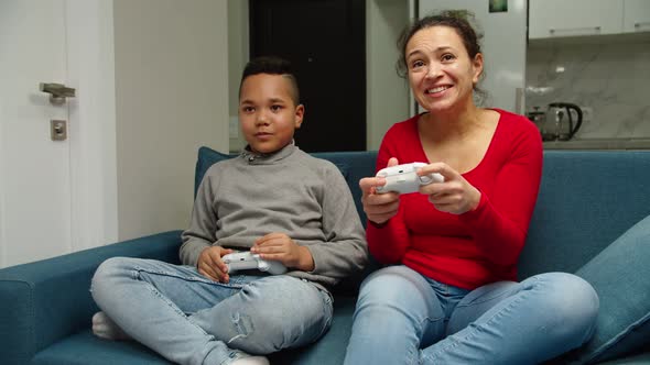Front Moving Shot of Mother and Son Playing Video Game at Home