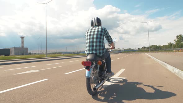 Young Man Riding Custom Motorcycle on Street Road Slow Motion