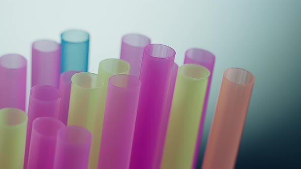 Multicolored plastic cocktail straws, close-up, camera movement