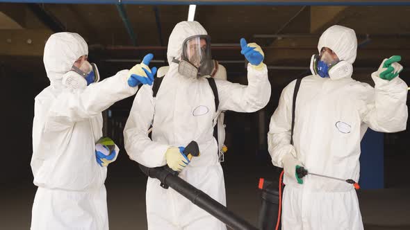 Happy Disinfectants Sprayers Wearing White Protective Uniform