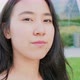 Slow motion portrait of young asiatic friendly woman posing outdoor smiling - VideoHive Item for Sale