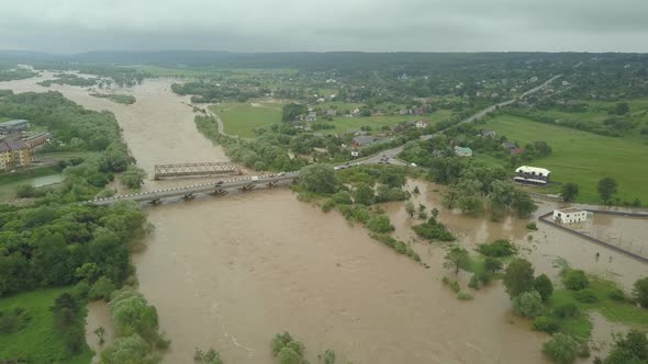 Aerial View of the Bridge During Floods. Extremely High Water Level in the River.