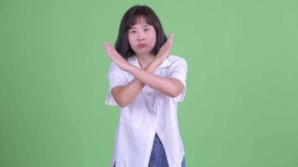 Stressed Asian Businesswoman with Stop Gesture