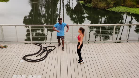 Aerial shot of a woman working out with a trainer in the park