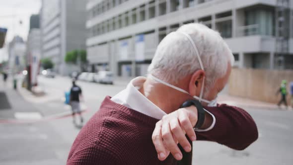 Caucasian man out and about in the street wearing on a face mask against coronavirus