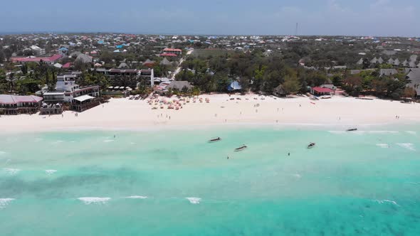 Exotic Sandy Beach with Turquoise Ocean Boats and Hotels Zanzibar Aerial View