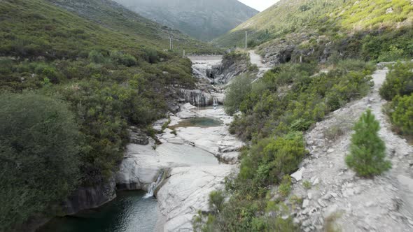 A mesmerizing flight in a rocky valley over a series of lakes falling from top to bottom, Portugal