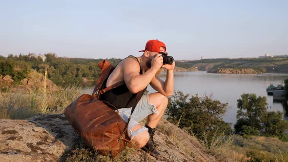 Hiker walking. Male traveler with traveling bag walking. Tourist photographer, hobby.