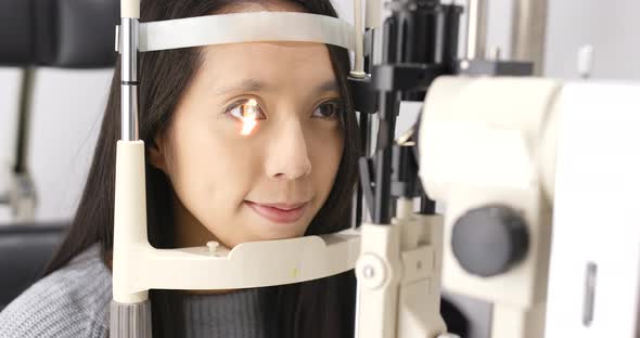 Young asian woman doing eye test 