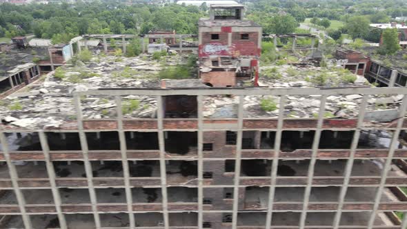 Abandoned Packard Automotive Plant in Detroit, Michigan drone video sweeping shot.