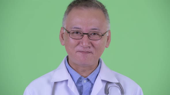 Face of Happy Mature Japanese Man Doctor Nodding Head Yes