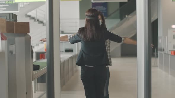 Physical Inspection of Female Tourist at Airport Checkpoint. Employee Checking Young Caucasian Woman