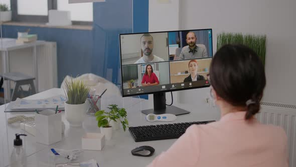 Executive Freelancer Looking Into Monitor Talking with Coworkers on Online Videocall