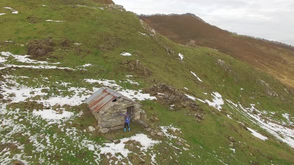 Aerial view of a trail runner and a small house