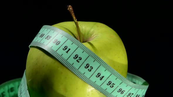 Green, Fresh Apple with Measuring Tape on White, Rotation, Reflection