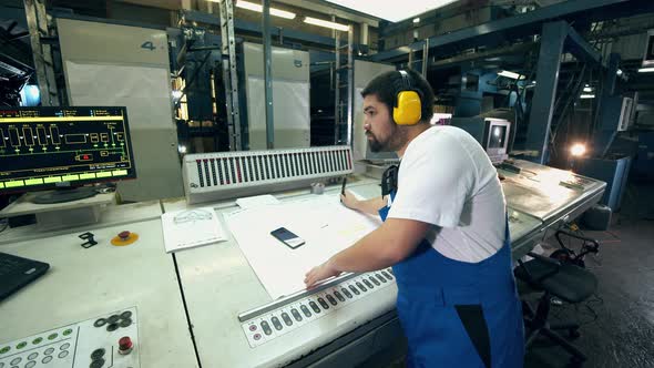 Male Engineer Is Working with Layouts in the Typography Unit