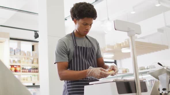 Animation of focused biracial waiter weighting cheese