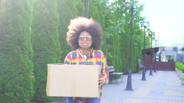 Cheerful African American Woman with an Afro Hairstyle with Box Slow Mo