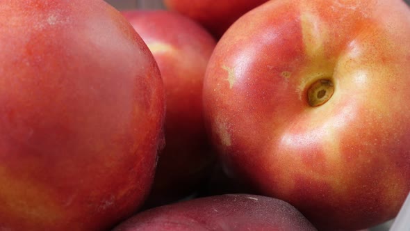 Red deciduous peach fruit in the box close-up 4K 2160p 30fps UltraHD tilting footage - Juicy Prunus 